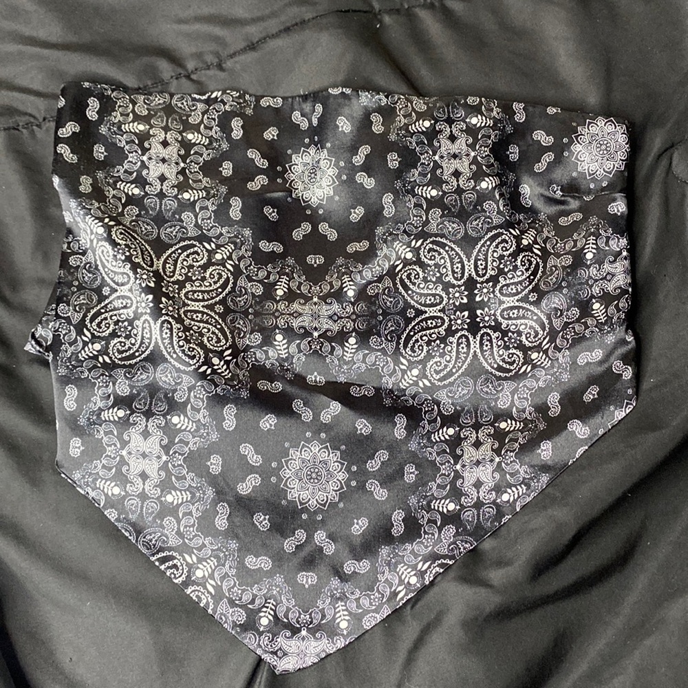 Black crop top with white print patters, not sure about the brand “large”
